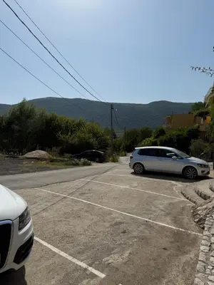 a white car parked in a parking lot at Monte Lastva Apartments in Podlastva