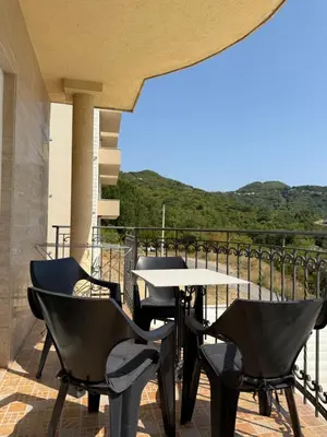 a table and chairs on a balcony with a view at Monte Lastva Apartments in Podlastva