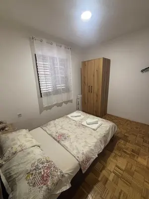 a bedroom with a large bed and a window at Bloom Home Bar in Bar
