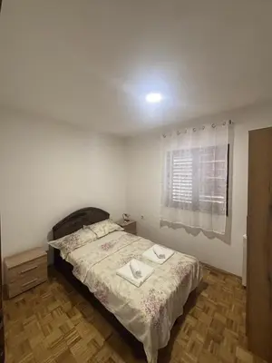 a bedroom with a bed and a window at Bloom Home Bar in Bar