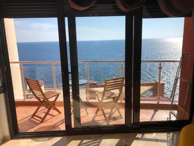 a balcony with chairs and a table and the ocean at Seaview apartment in Dobra Voda