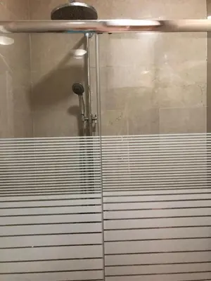a shower with a glass door in a bathroom at Seaview apartment in Dobra Voda