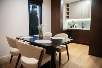 a dining room with a black table and chairs at Villa Teona KotorBay Residence in Kotor