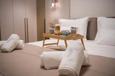 a bed with a tray of towels and a table on it at Villa Teona KotorBay Residence in Kotor