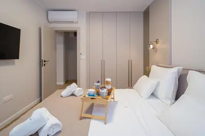 a hotel room with a bed and a table with towels at Villa Teona KotorBay Residence in Kotor
