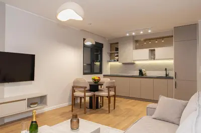 a kitchen and living room with a couch and a table at Villa Teona KotorBay Residence in Kotor