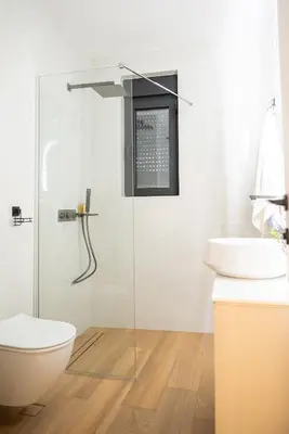 a bathroom with a shower and a toilet and a sink at Villa Teona KotorBay Residence in Kotor