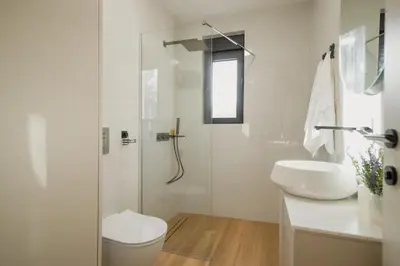 a bathroom with a shower and a toilet and a sink at Villa Teona KotorBay Residence in Kotor