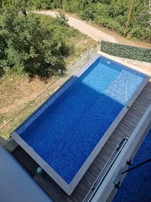 an overhead view of a swimming pool with blue water at Rafailovići Hill in Budva