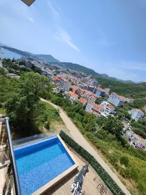 a swimming pool with a view of a city at Rafailovići Hill in Budva