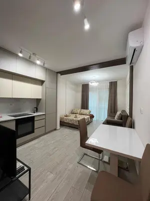 a living room with a kitchen and a dining room at FAB LIFE Becici in Becici