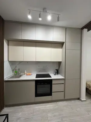 a kitchen with white cabinets and a stove top oven at FAB LIFE Becici in Becici