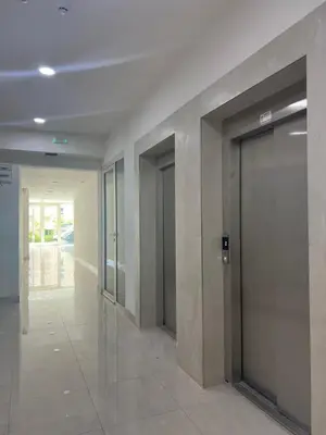 an empty hallway with doors in a building at FAB LIFE Becici in Becici