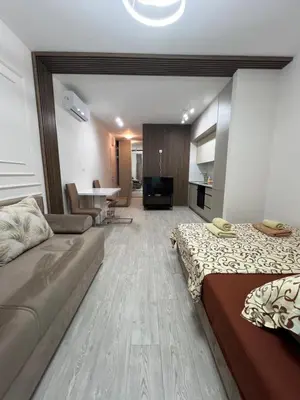 a living room with a couch and a living room with a table at FAB LIFE Becici in Becici