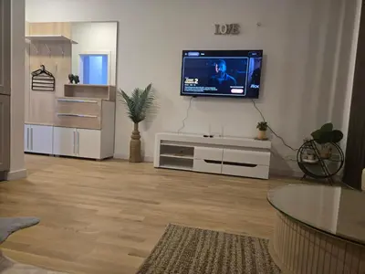 a living room with a flat screen tv on a wall at Apartment Lule in Bar