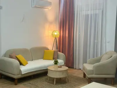 a living room with a couch and two chairs at Apartment Lule in Bar