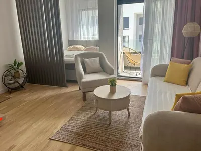 a living room with a couch and a table and a bed at Apartment Lule in Bar
