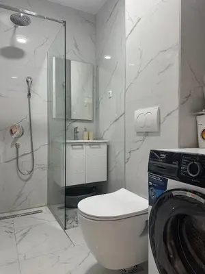a bathroom with a toilet and a glass shower at Apartment Lule in Bar