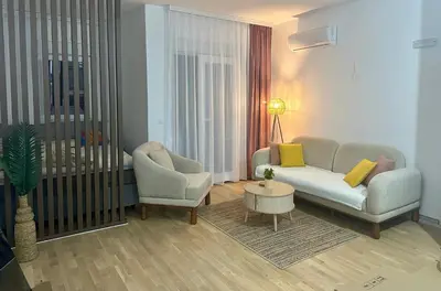 a living room with a couch and a chair and a table at Apartment Lule in Bar