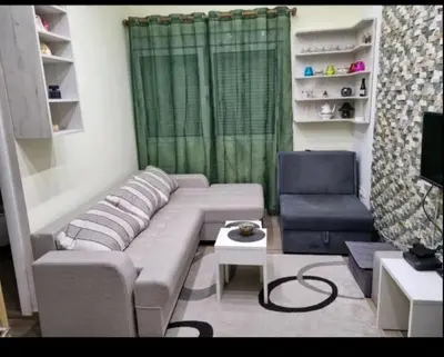 a living room with a couch and a chair at Apartman Duki in Budva