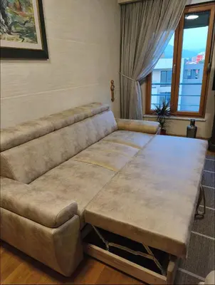 a couch with a table in a living room at Kraljev park in Podgorica