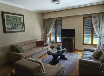 a living room with a couch and a table at Kraljev park in Podgorica