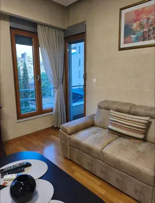 a living room with a couch and a table at Kraljev park in Podgorica