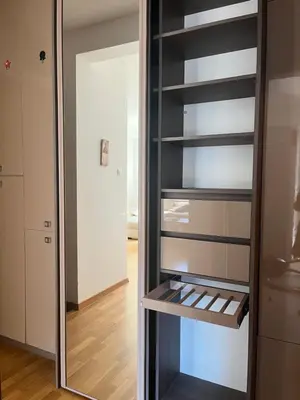 a glass refrigerator with a mirror in a room at Apartman Mega Budva in Budva