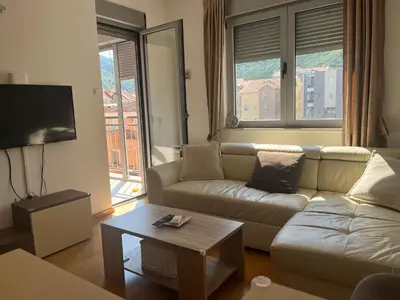 a living room with a couch and a table at Apartman Mega Budva in Budva