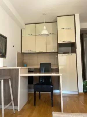 a black chair sitting at a desk in a room at Apartman Mega Budva in Budva