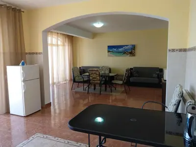 a kitchen and living room with a table and a refrigerator at Apartment Barski in Bar