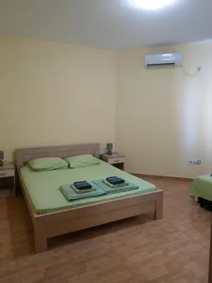 a bedroom with a bed with two towels on it at Apartment Barski in Bar