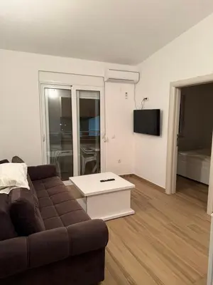a living room with a couch and a table at Bregvija Apartments in Donji Štoj