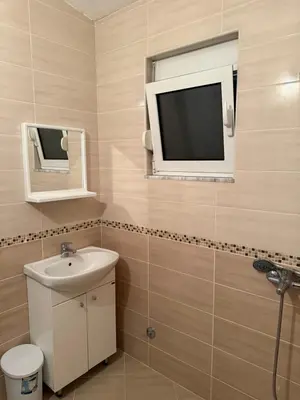 a bathroom with a sink and a tv on the wall at Bregvija Apartments in Donji Štoj