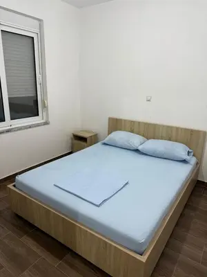 a large bed in a room with a window at Bregvija Apartments in Donji Štoj