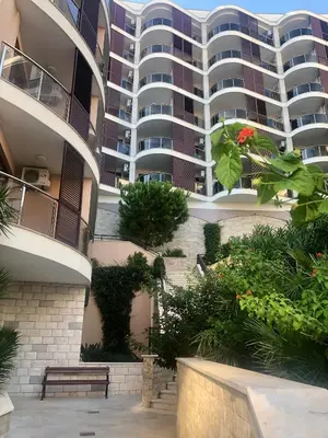 a large apartment building with a garden in front of it at Anatolia Luxury Seaview Residence in Becici