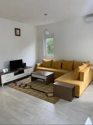 a living room with a couch and a tv at I&A Apartments in Ulcinj