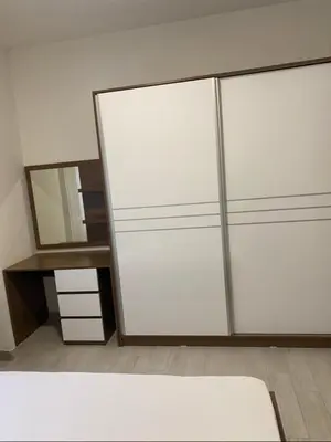 a closet with white doors and a mirror at I&A Apartments in Ulcinj