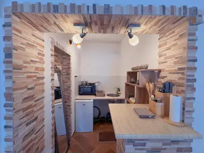 an office with a brick wall and a desk at Sunny Nest Studio Bar in Bar
