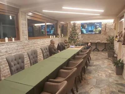 a long table in a restaurant with people sitting around it at Sunny Nest Studio Bar in Bar