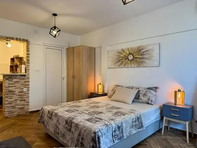 a bedroom with a king sized bed in a room at Sunny Nest Studio Bar in Bar