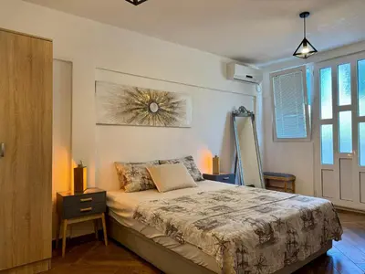 a bedroom with a large bed and a window at Sunny Nest Studio Bar in Bar