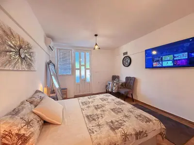 a bedroom with a large bed in a room at Sunny Nest Studio Bar in Bar