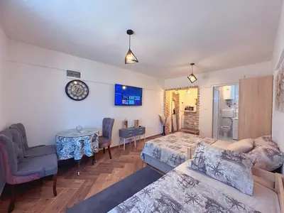 a living room with a couch and a table at Sunny Nest Studio Bar in Bar