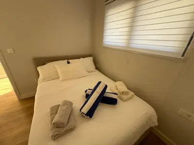 a bedroom with a bed with towels and a window at SeaView Suite with Pool near Tivat Airport by Solea Vacation Homes in Tivat