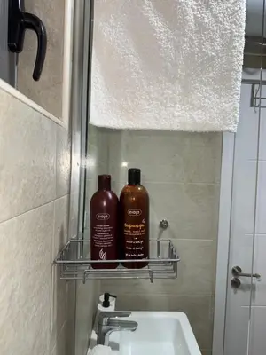 two bottles of soap sitting on a shelf above a sink at SeaView Suite with Pool near Tivat Airport by Solea Vacation Homes in Tivat