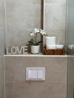 a shelf in a bathroom with a love sign on it at SeaView Suite with Pool near Tivat Airport by Solea Vacation Homes in Tivat