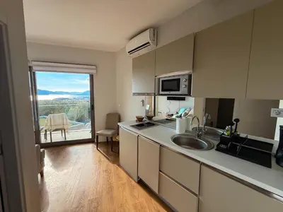 a kitchen with a sink and a large window at SeaView Suite with Pool near Tivat Airport by Solea Vacation Homes in Tivat