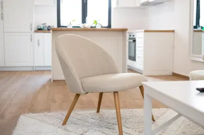 a white chair in a kitchen with a table at Tarik Apartment in Ulcinj