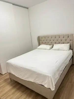 a bedroom with a large bed with white sheets and pillows at Vila Dusan in Bar